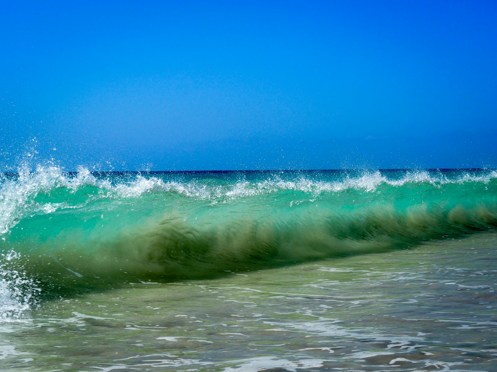 ocean waves under blue sky during daytime